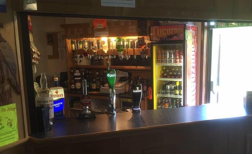 Village bar with bottles and beer taps